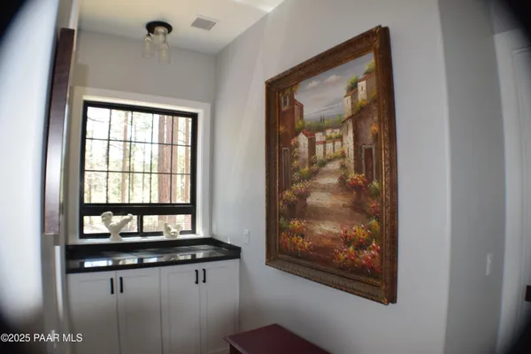 a kitchen with cabinets and window
