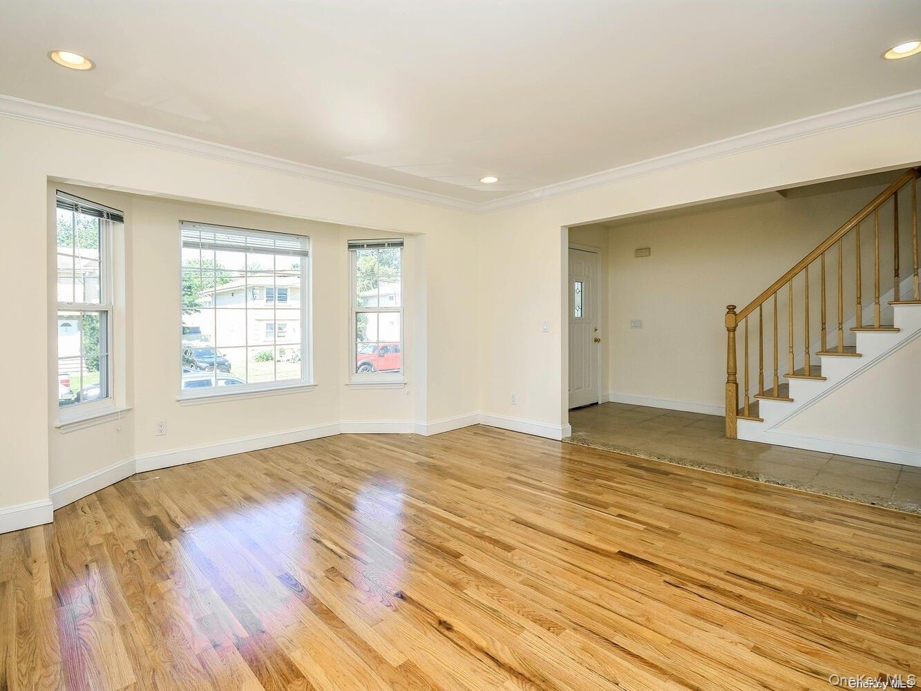 34 Firwood Road, Unit B Port Washington, NY 11050 - Photo 2 of 25 a view of an empty room with wooden floor and a window