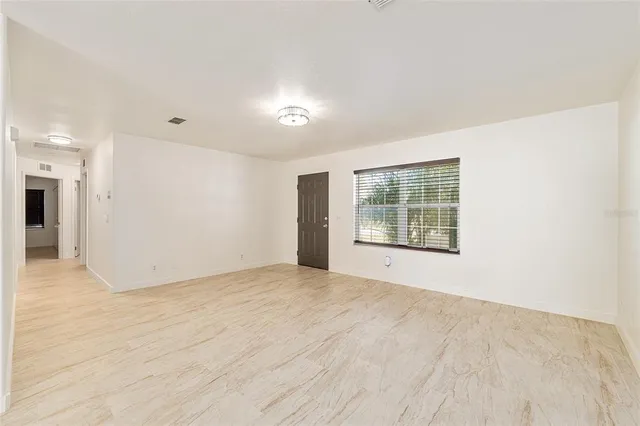 a view of an empty room with a window