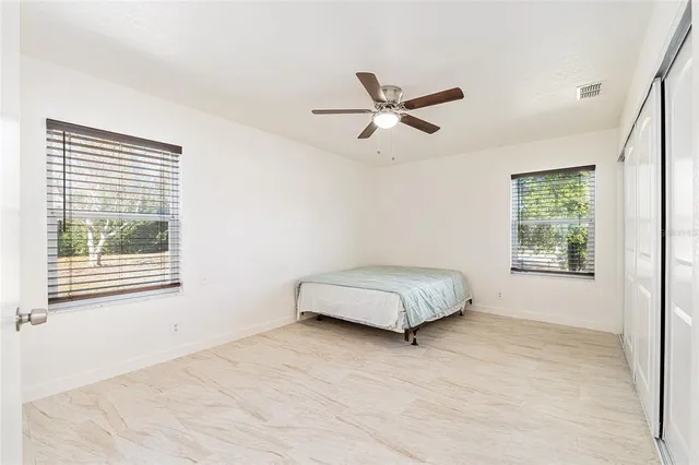 a bedroom with a bed and a window