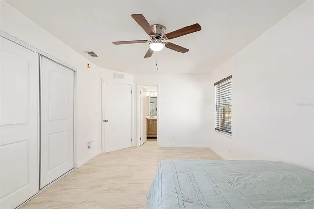 a view of a livingroom with a ceiling fan and window