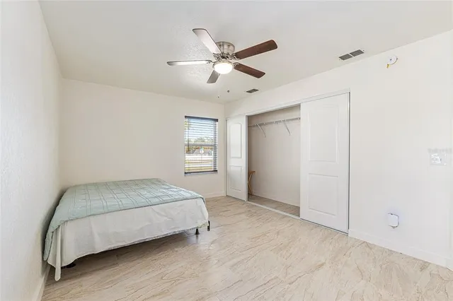 a bedroom with a bed and window
