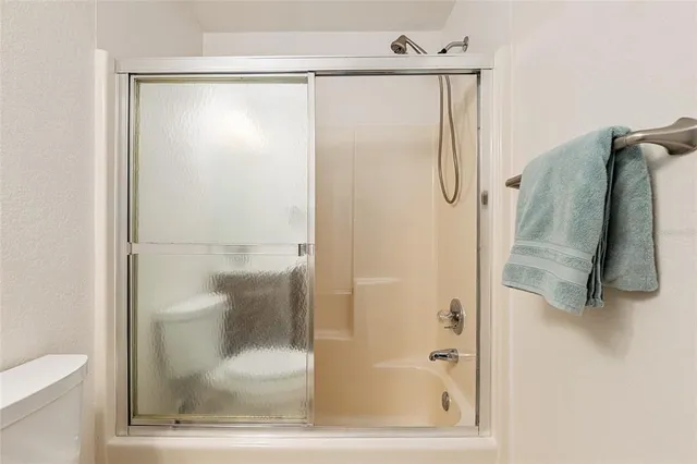 a bathroom with a glass shower door
