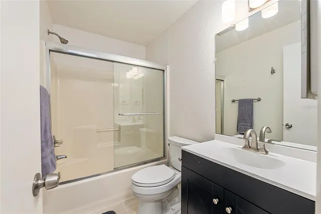 a bathroom with a shower a toilet and sink