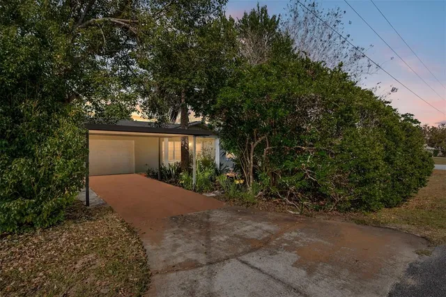 a view of a house with a yard and garage