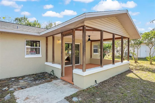 a view of a yard with plants and trees