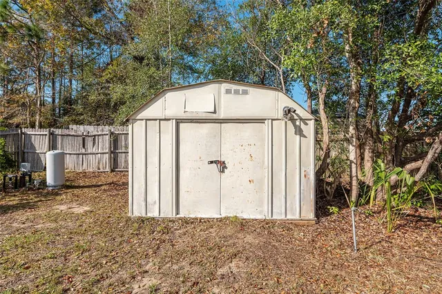 a view of backyard of house with green space