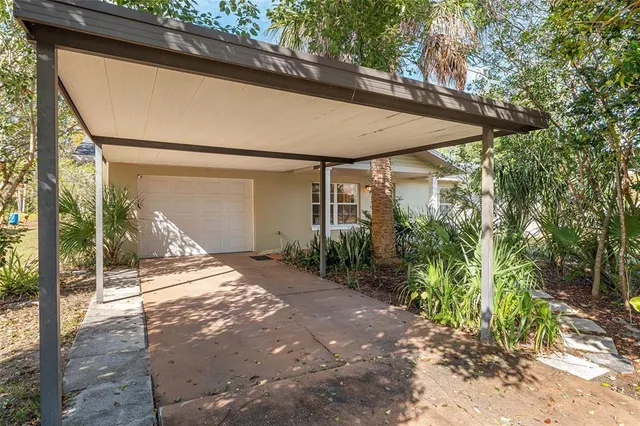 a view of a patio with table and chairs under an umbrella