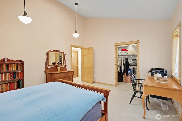 a bedroom with furniture and a book shelf