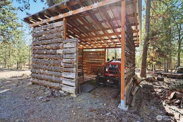 a view of a yard with wooden fence