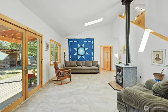 a living room with furniture and a floor to ceiling window