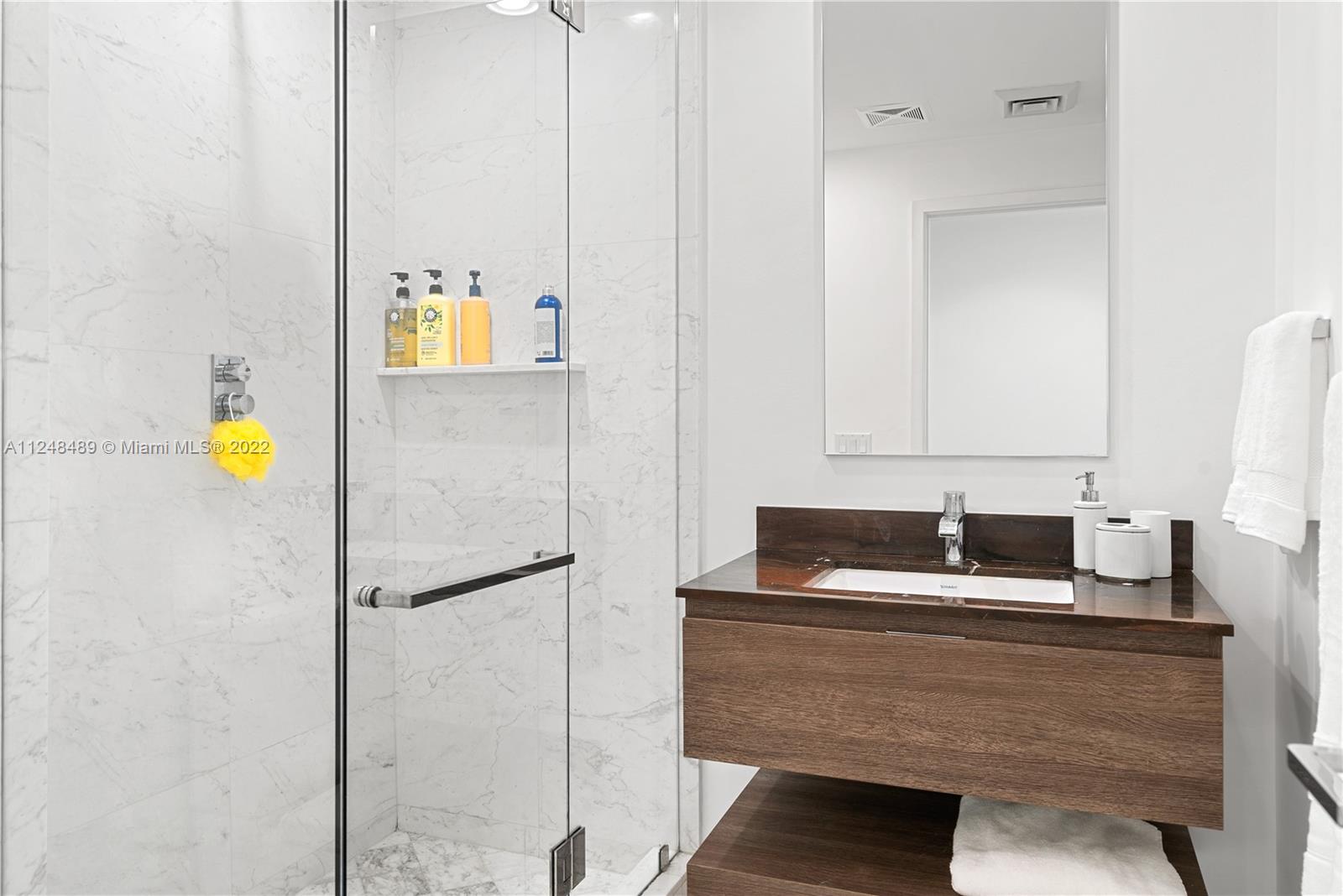 360 Ocean Drive, Unit 1106S Key Biscayne, FL 33149 - Photo 23 of 46 a bathroom with a sink and a mirror