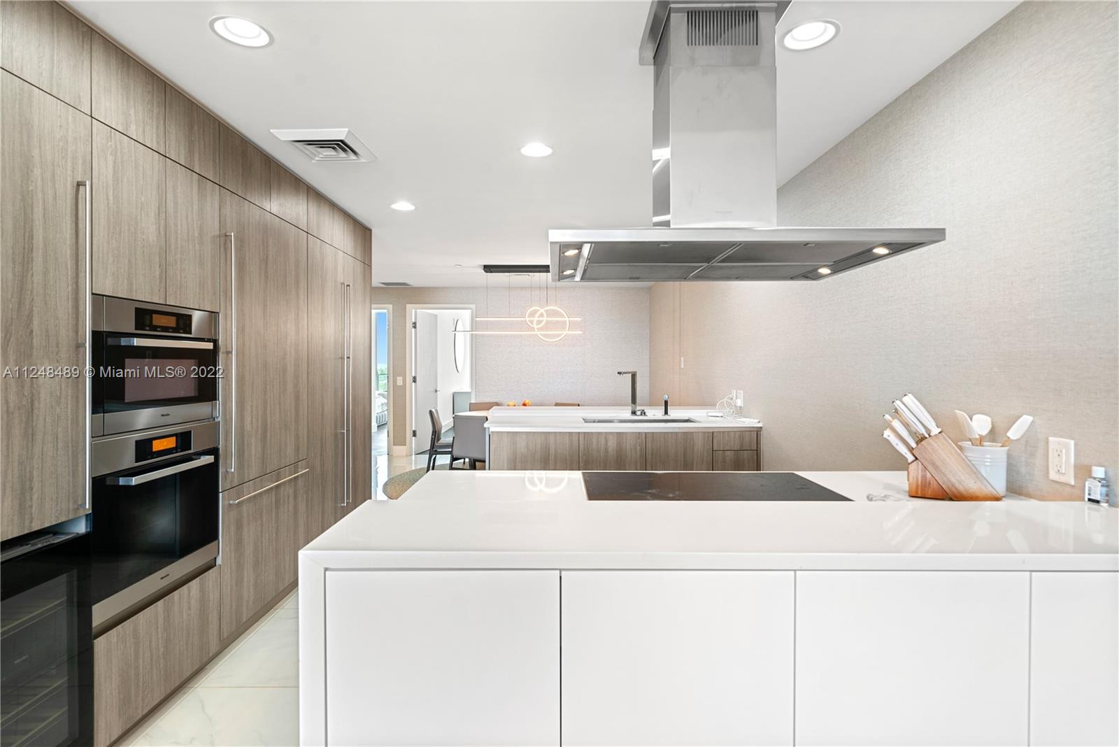 360 Ocean Drive, Unit 1106S Key Biscayne, FL 33149 - Photo 8 of 46 a kitchen with stainless steel appliances a refrigerator and a stove top oven