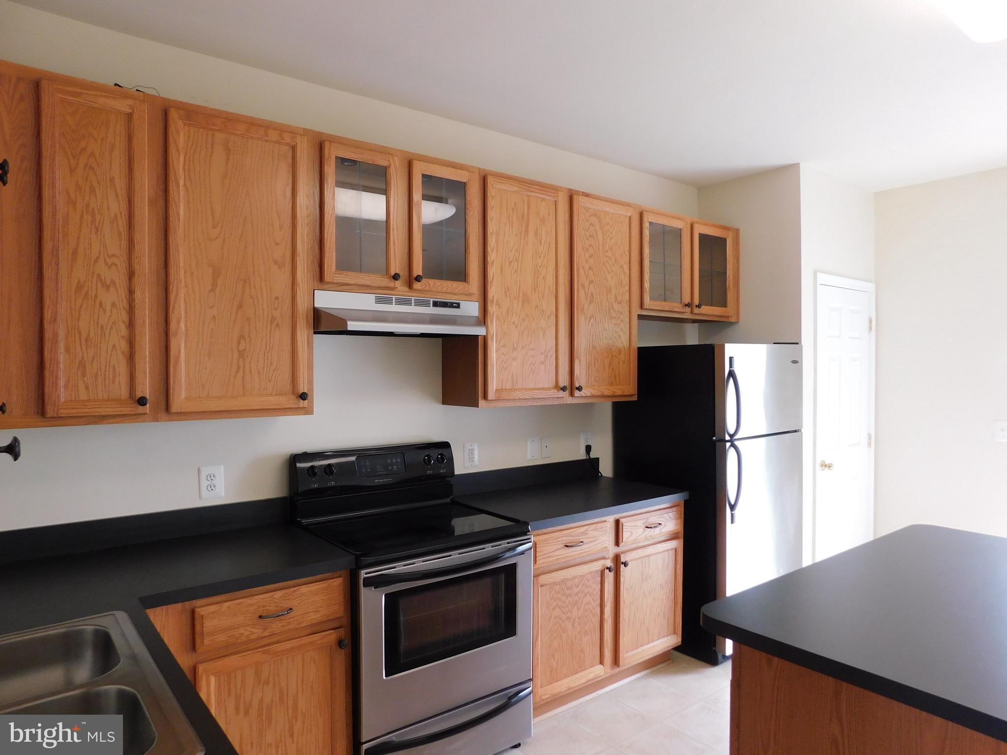4036 Cutty Sark Road Baltimore, MD 21220 - Photo 15 of 25 a kitchen with stainless steel appliances granite countertop a stove a refrigerator and a microwave