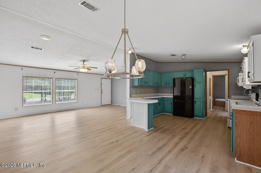 54059 Charles Street Callahan, FL 32011 - Photo 11 of 50 a view of a kitchen with wooden floor