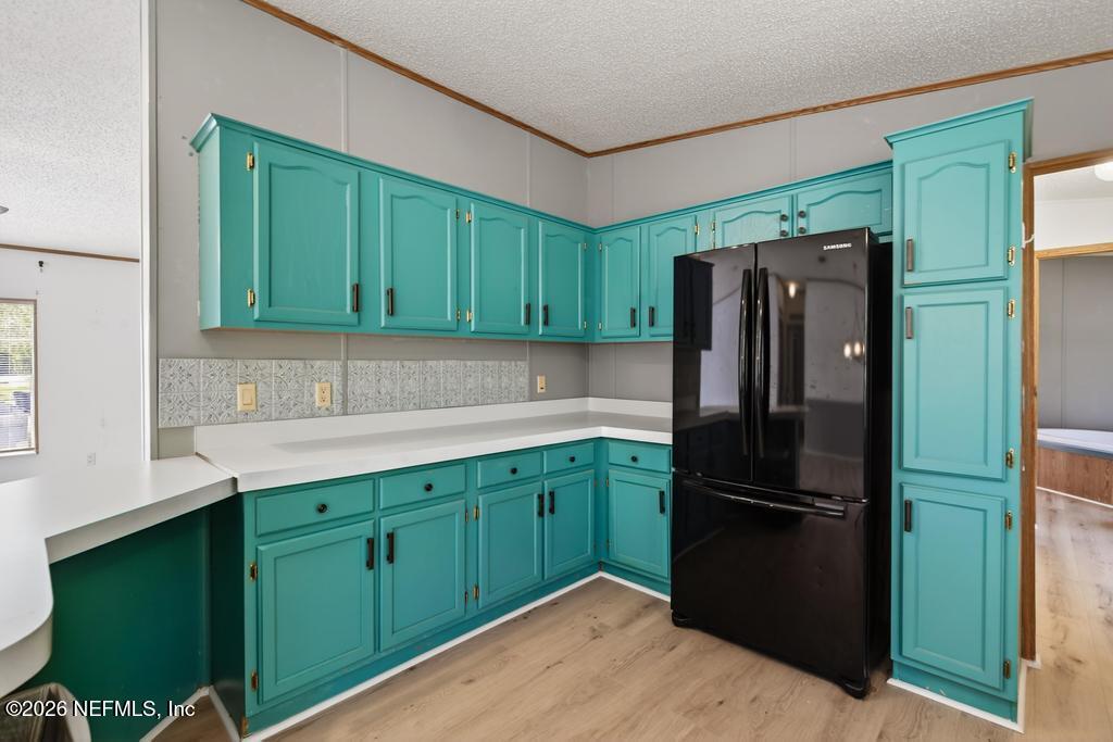 54059 Charles Street Callahan, FL 32011 - Photo 16 of 50 a kitchen with stainless steel appliances granite countertop a refrigerator and a sink