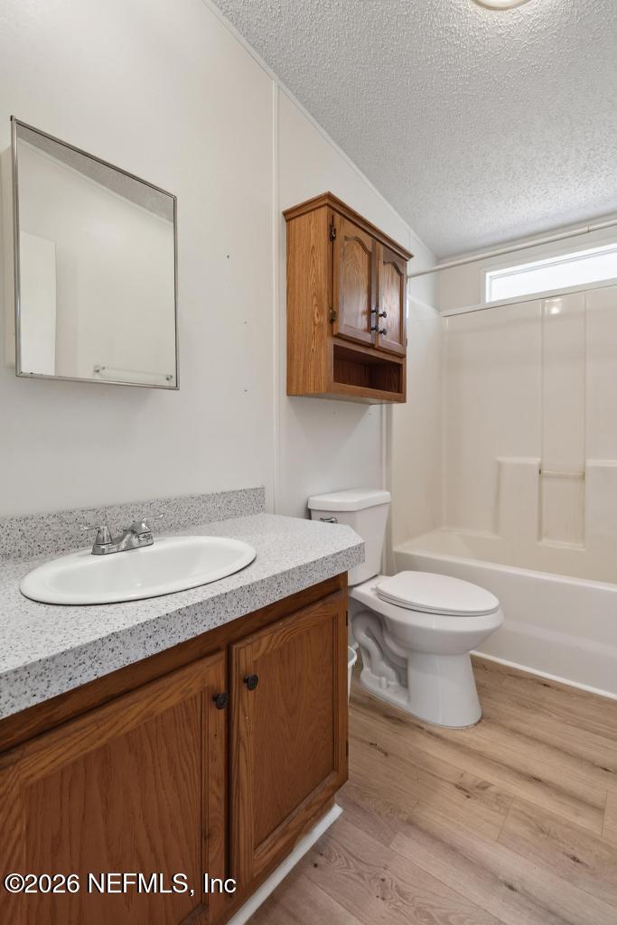 54059 Charles Street Callahan, FL 32011 - Photo 23 of 50 a bathroom with a granite countertop toilet sink and mirror