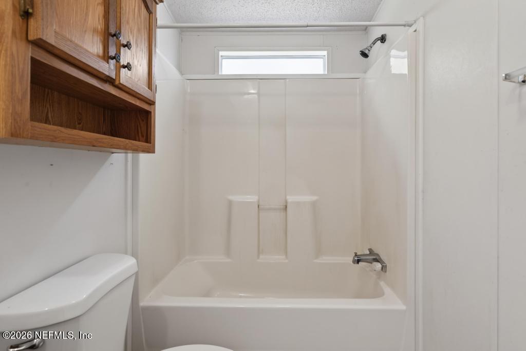 54059 Charles Street Callahan, FL 32011 - Photo 24 of 50 a bathroom with a bathtub and a toilet