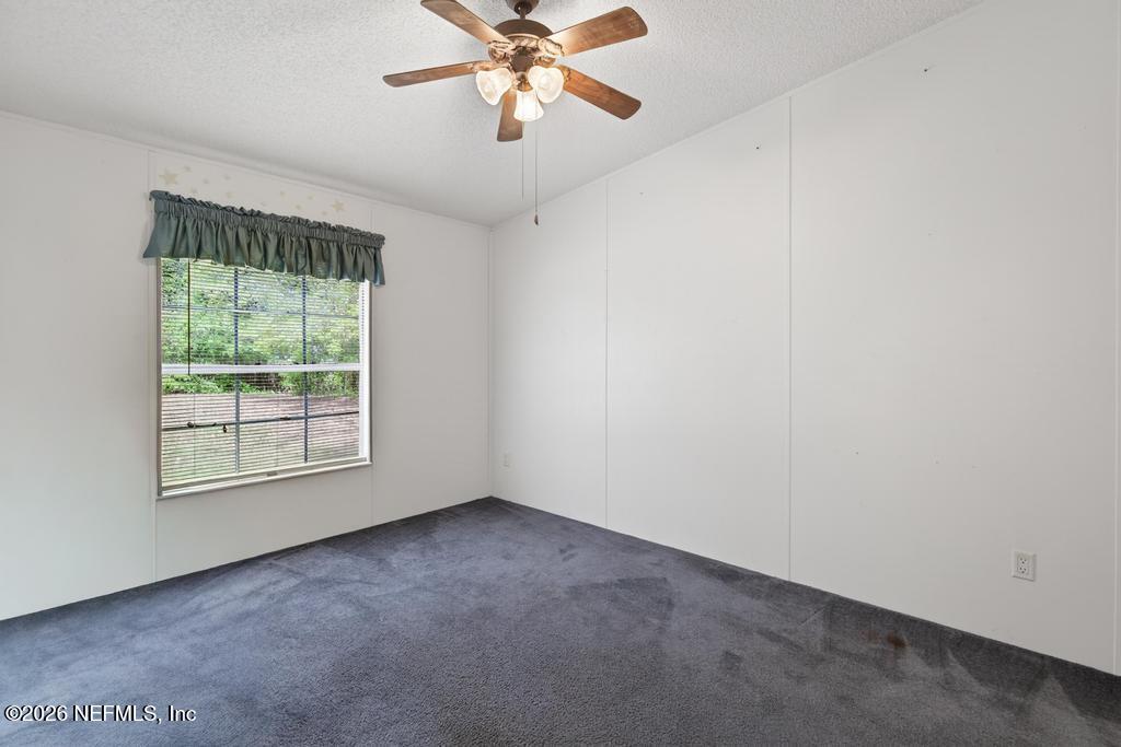 54059 Charles Street Callahan, FL 32011 - Photo 25 of 50 an empty room with a window and a fan
