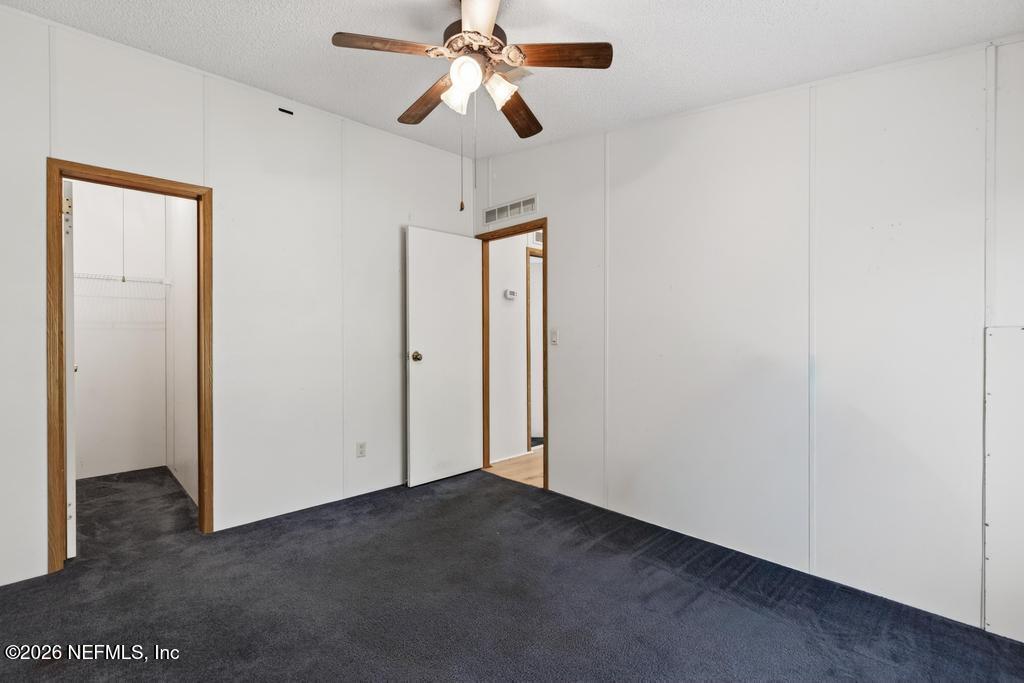 54059 Charles Street Callahan, FL 32011 - Photo 26 of 50 an empty room with closet and a chandelier fan