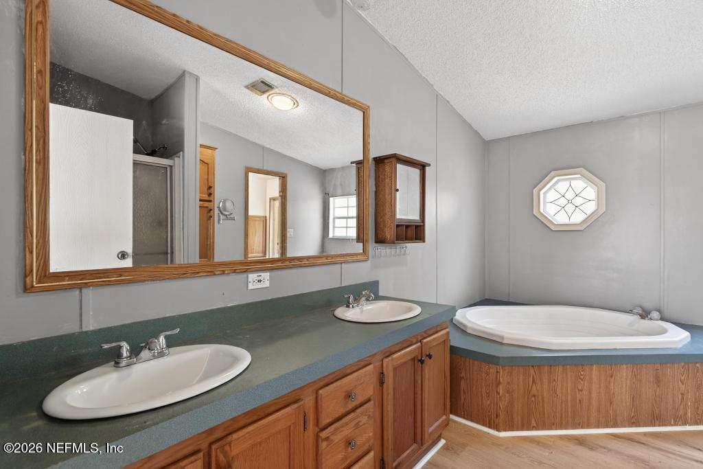 54059 Charles Street Callahan, FL 32011 - Photo 29 of 50 a bathroom with a sink and a mirror