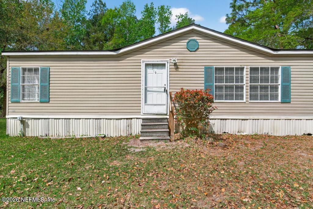 54059 Charles Street Callahan, FL 32011 - Photo 3 of 50 a front view of a house with a yard