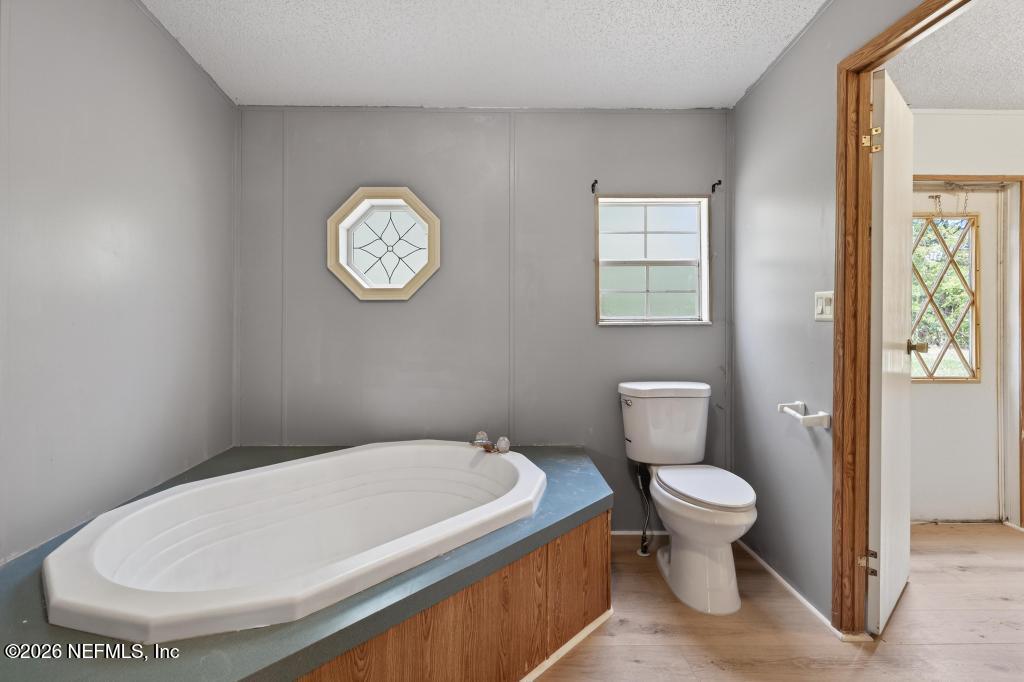 54059 Charles Street Callahan, FL 32011 - Photo 33 of 50 a bathroom with a toilet and a sink