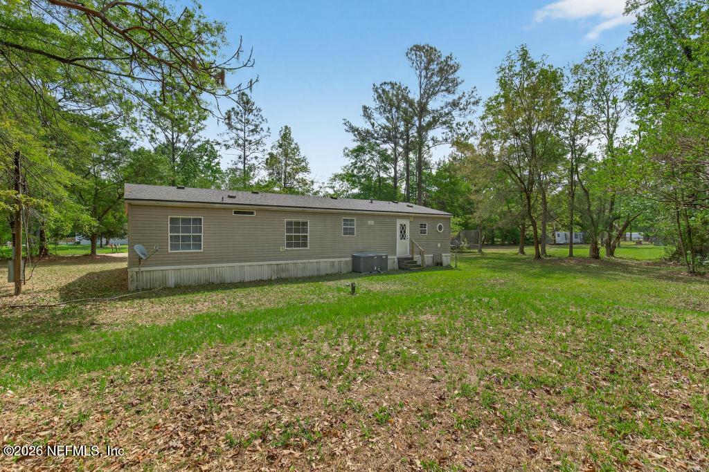 54059 Charles Street Callahan, FL 32011 - Photo 37 of 50 a view of a house with a backyard