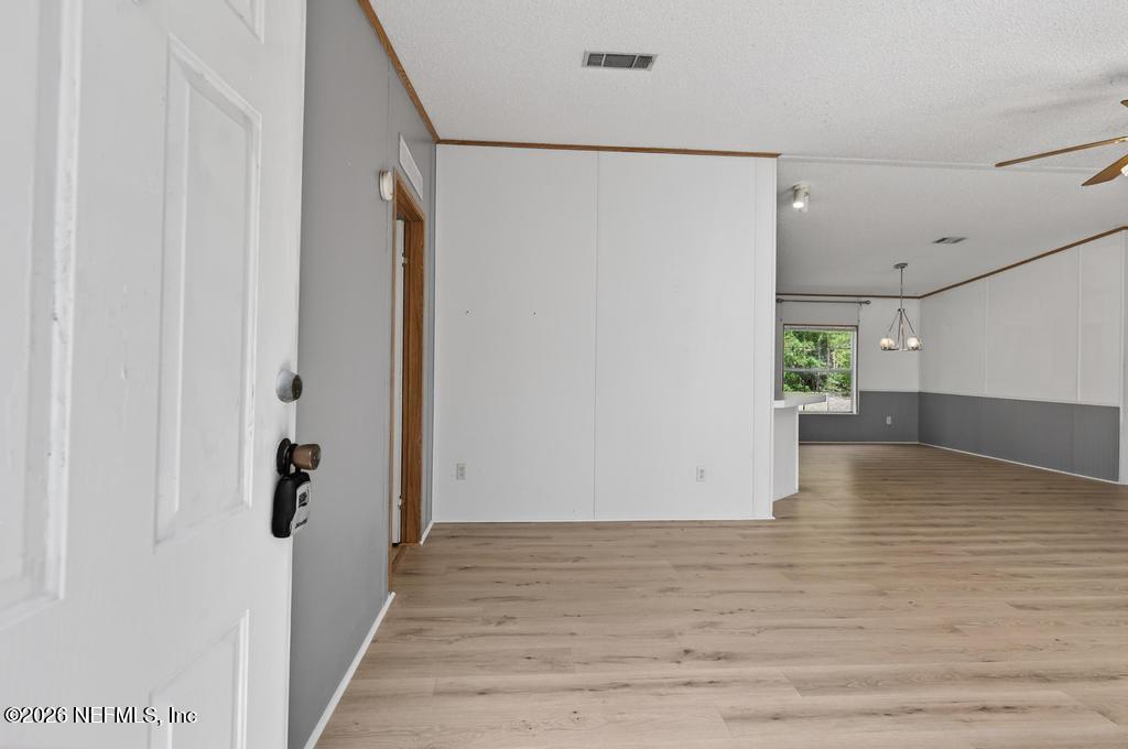54059 Charles Street Callahan, FL 32011 - Photo 4 of 50 a view of empty room with wooden floor