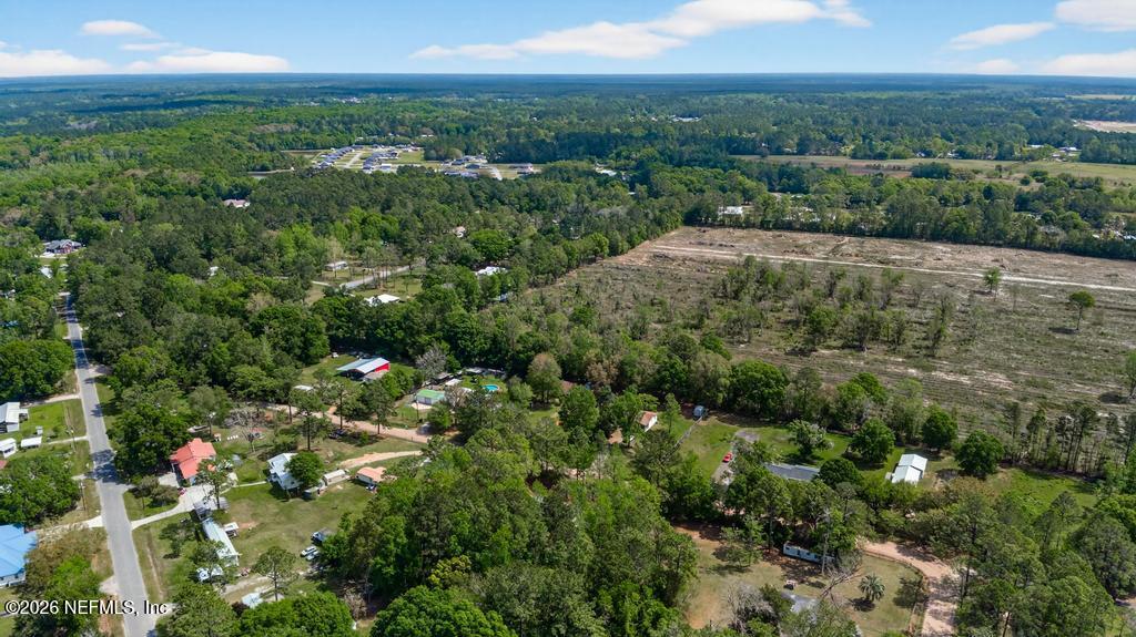 54059 Charles Street Callahan, FL 32011 - Photo 45 of 50 an aerial view of residential houses with outdoor space and trees