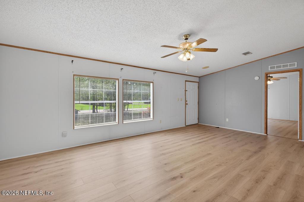 54059 Charles Street Callahan, FL 32011 - Photo 9 of 50 a view of a room with a ceiling fan and a window