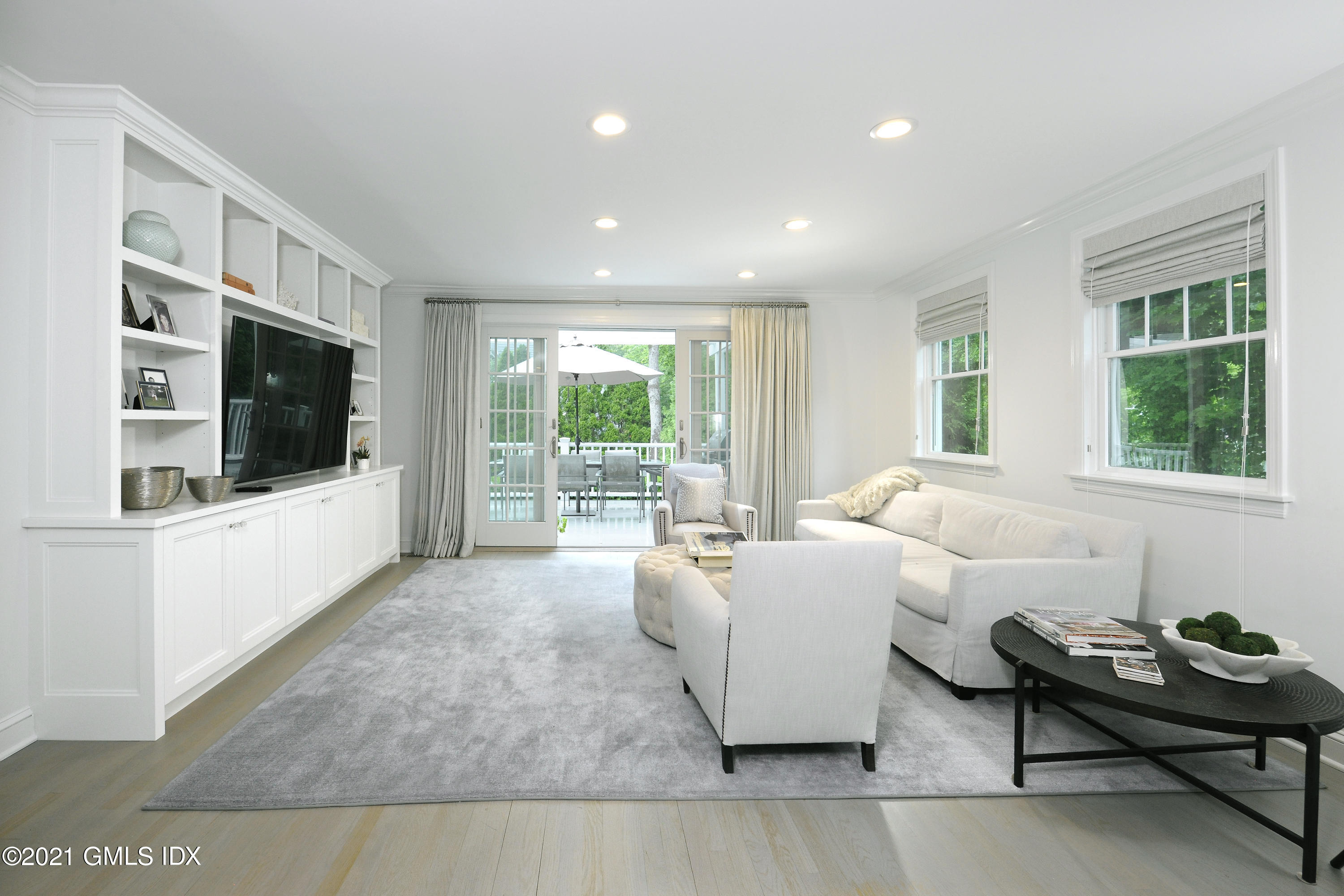 145 Shore Road Old Greenwich, CT 06870 - Photo 11 of 25 a living room with furniture and a flat screen tv