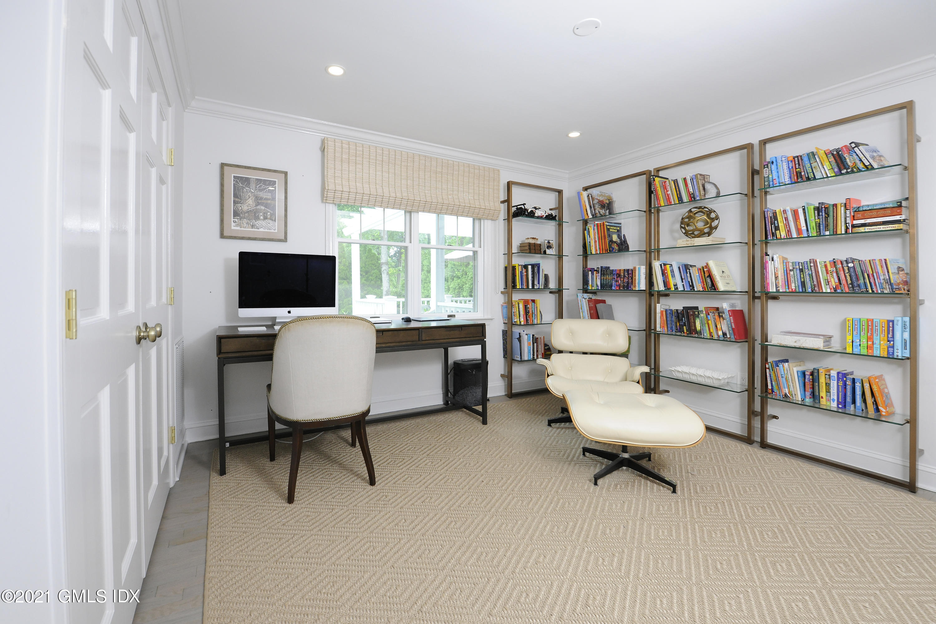 145 Shore Road Old Greenwich, CT 06870 - Photo 12 of 25 a living room with furniture and a book shelf