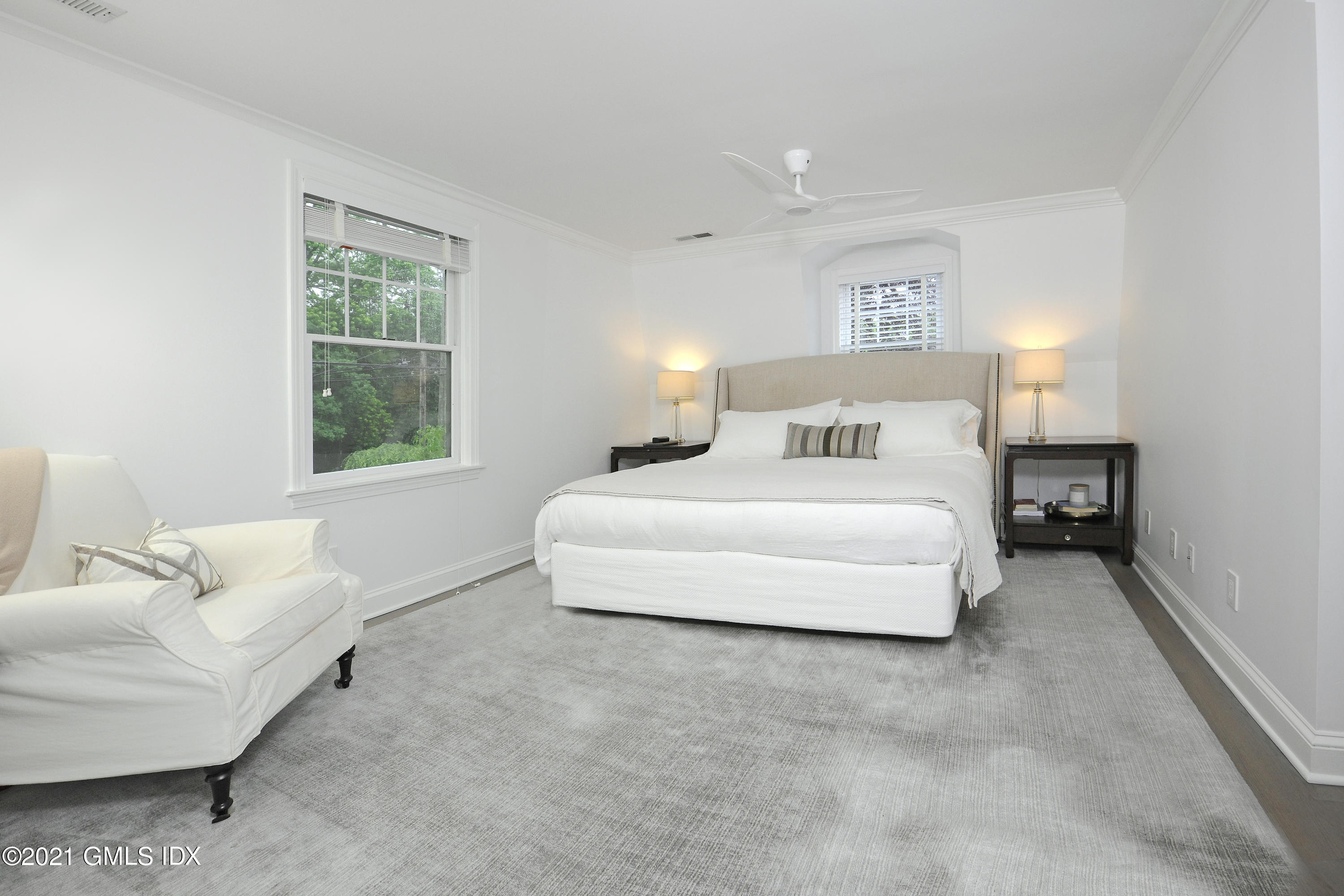 145 Shore Road Old Greenwich, CT 06870 - Photo 14 of 25 a spacious bedroom with a bed and a couch