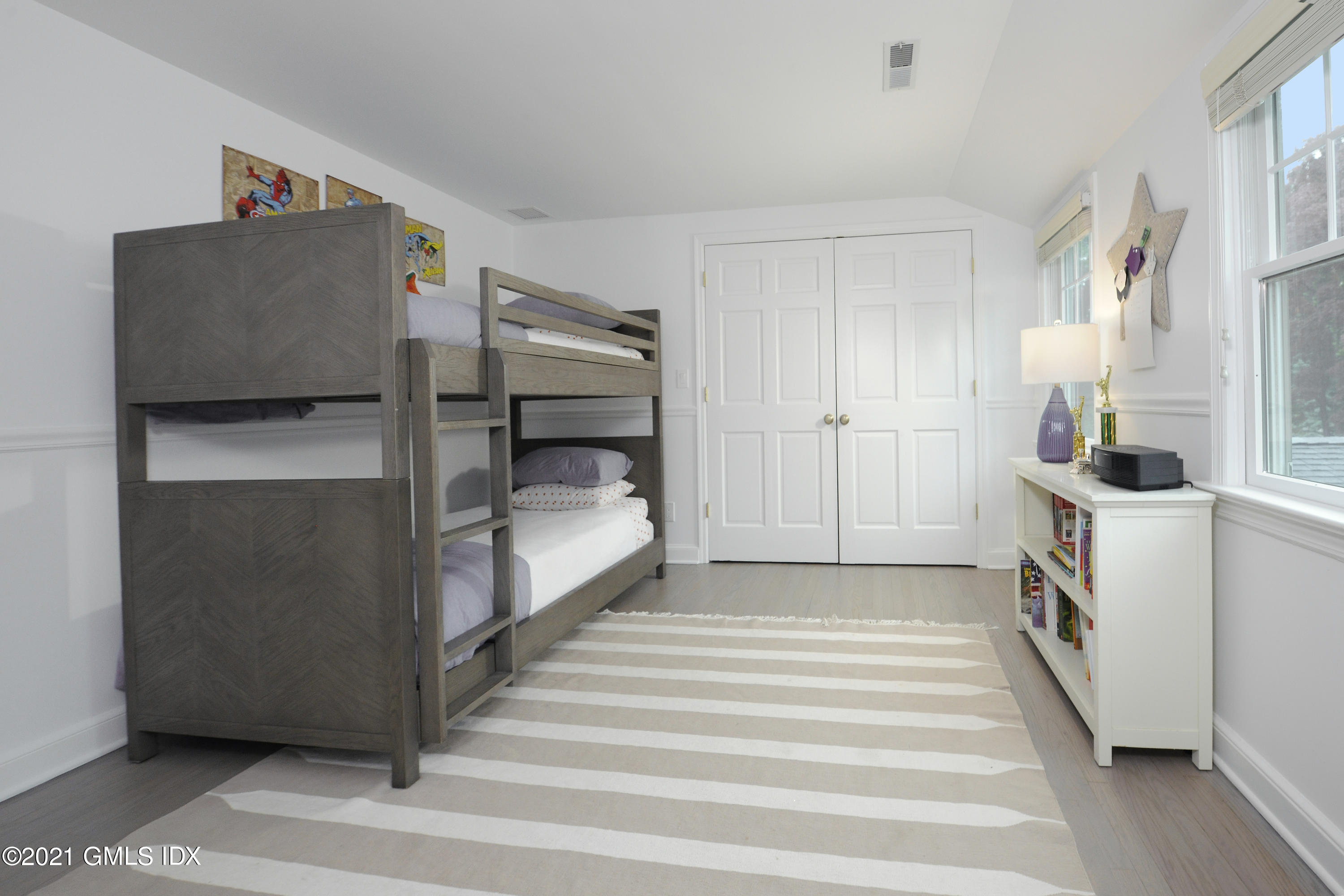 145 Shore Road Old Greenwich, CT 06870 - Photo 16 of 25 a bedroom with bed and cabinets