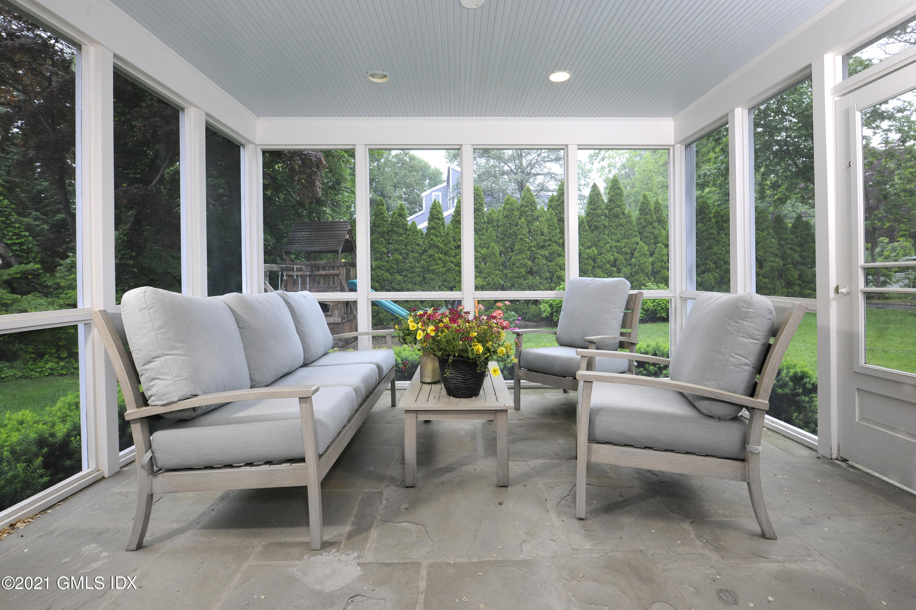 145 Shore Road Old Greenwich, CT 06870 - Photo 6 of 25 a living room with furniture and a floor to ceiling window