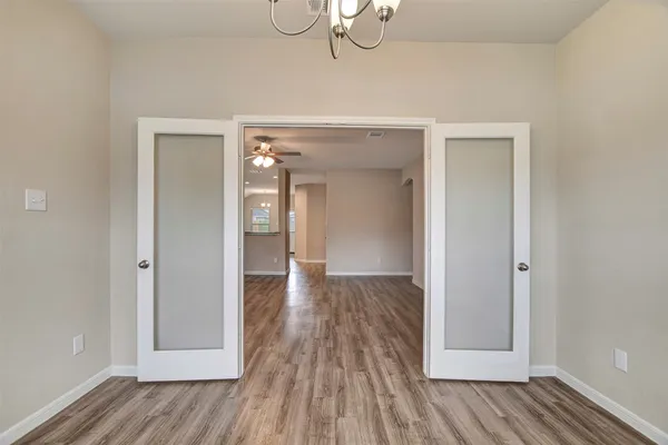 a view of a kitchen with a sink and wooden floor