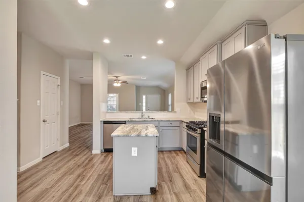 a view of a walk in closet and wooden floor