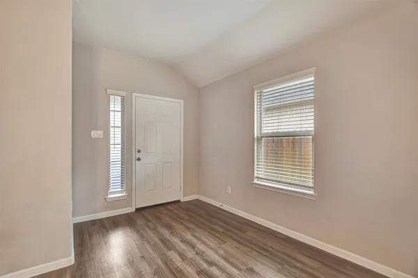 a view of wooden floor and a chandelier fan in a room