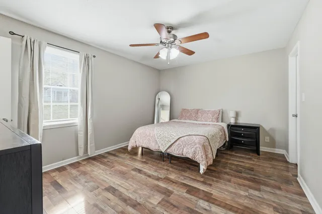 a bedroom with a bed and wooden floor