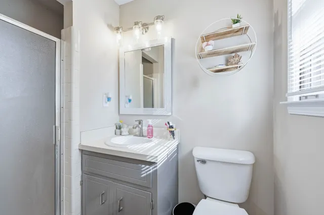 a bathroom with a toilet sink and mirror