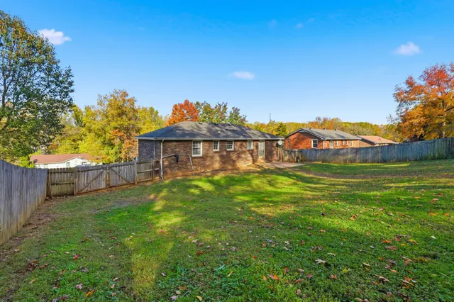 a view of a house with a backyard and a garden