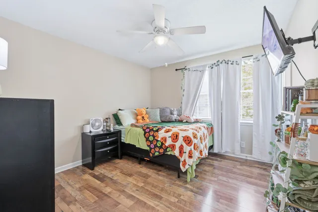 a bedroom with a bed and a chandelier