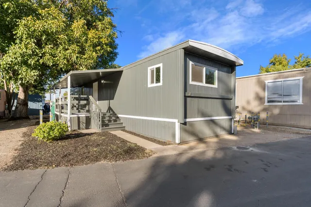 a backyard of a house with table and chairs