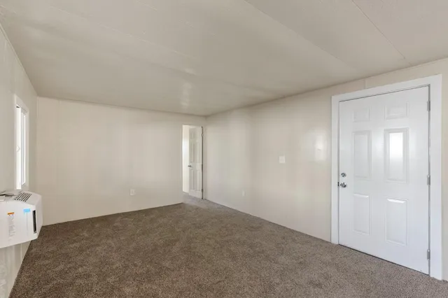 a view of an empty room and closet area