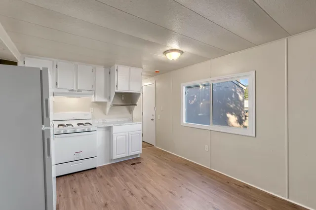 a kitchen with stainless steel appliances granite countertop a stove and a refrigerator