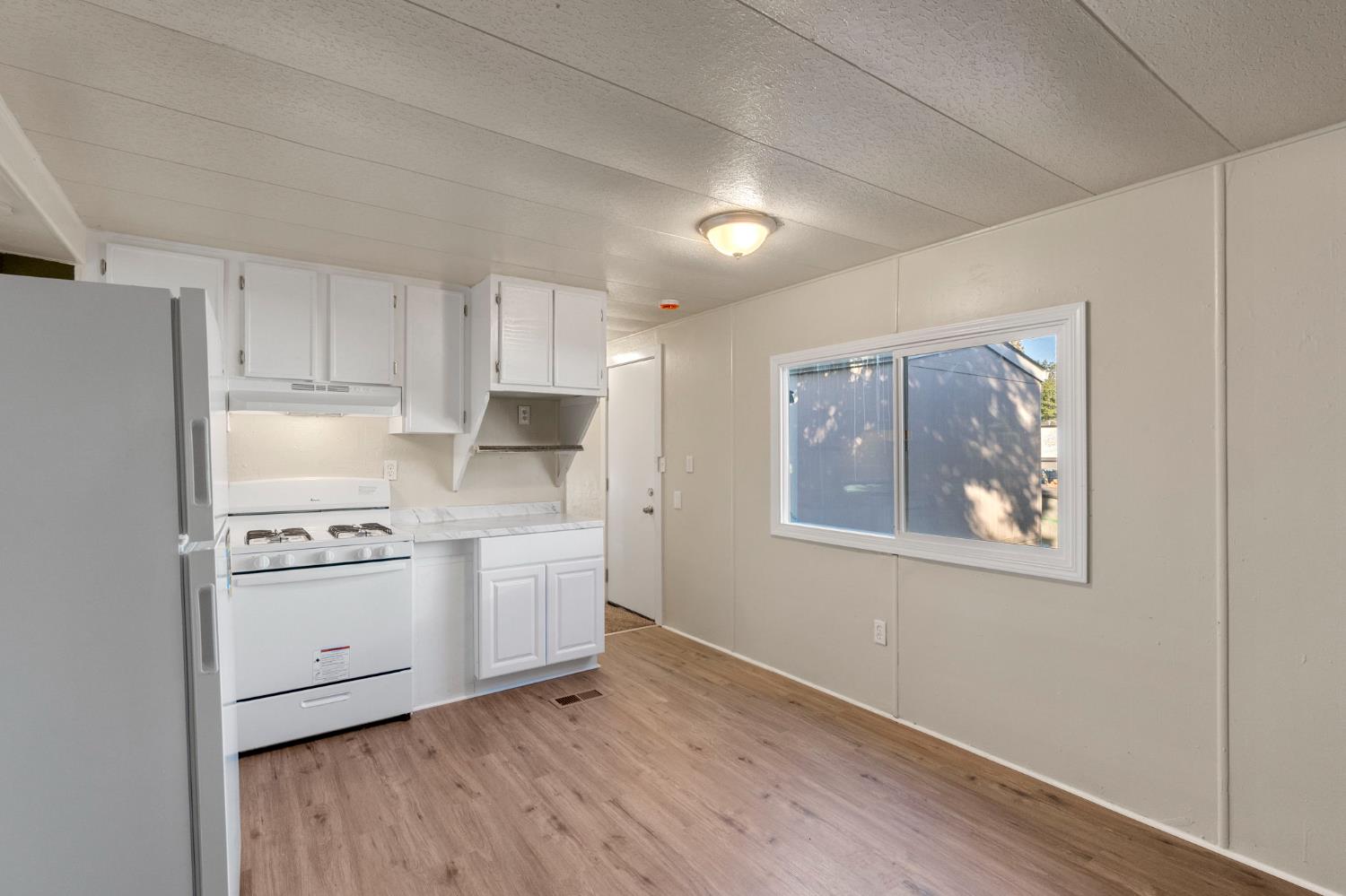 1523 North Beale Road, Unit 38 Marysville, CA 95901 - Photo 14 of 24 a kitchen with stainless steel appliances granite countertop a stove and a refrigerator