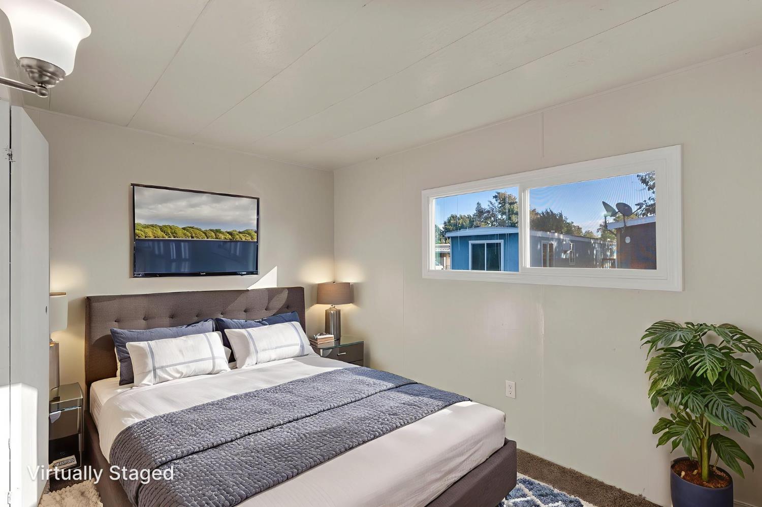 1523 North Beale Road, Unit 38 Marysville, CA 95901 - Photo 21 of 24 a bedroom with a bed and a painting on the wall