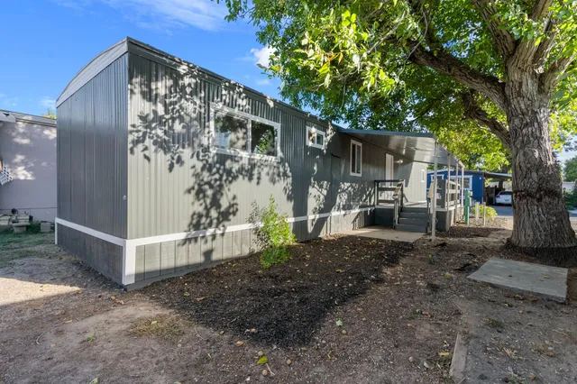 a view of a house with a yard and tree s