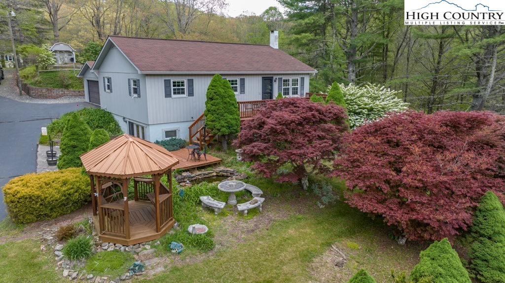 1268 Pine Run Road Boone, NC 28607 - Photo 1 of 48 a aerial view of a house with a yard table and chairs
